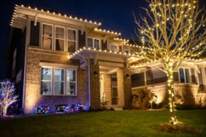 A beautifully decorated Indianapolis home with roofline and tree lights installed by Indy Christmas Light Pros, showcasing professional holiday lighting installation quality and attention to detail.